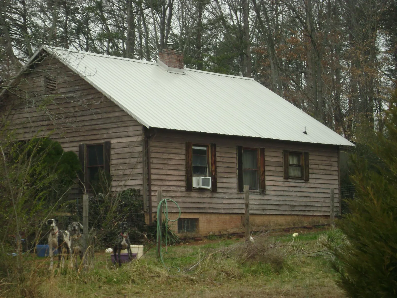White metal roof on an old wood sided farmhouse, from a Metal Roof Installation job in Sabattus